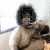 A pixelated figure with an afro hairstyle appears in multiple poses across four , showing variations in hand position and facial expression