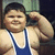 A child in a blue wrestling singlet flexes his bicep, smiling with eyes closed against a green and dark background.