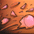 Animated sequence showing a pink creature with multiple eyes on an orange background, followed by a white mask-like face with large circular eyes and vertical stitching lines.