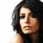 Pixelated close-up of a person with dark shoulder-length hair, light skin tone, and visible facial features against white background.