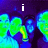 A four- displays a pixelated image with green and blue figures against dark purple background, text changes