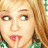 Pixelated close-up of a person with light brown hair, fair skin, and red lips, wearing a green and white checkered garment.