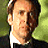 Two side-by-side pixelated portraits of a man with brown hair, one in dark clothing against green background, the other in light clothing against brown background.