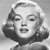 Black-and-white pixelated image of a person with short hair, hand raised near face, closed eyes, and mouth slightly open in a neutral expression.