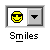 Pixelated yellow smiley face with black sunglasses inside a white square, next to a gray dropdown arrow and below the word 'Smiles' in pixel font.