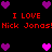 Pixelated red text reads "I LOVE Nick Jonas!" on a black background, surrounded by purple and pink heart icons.