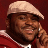 Pixelated static image of a person wearing a light-colored cap and red clothing against a dark background, with visible dithering and low-resolution rendering artifacts.