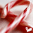Red and white striped candy cane with small heart shapes, featuring pixelated text reading 'all i want for christmas is you' on the right side.