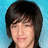 Pixelated portrait of a person with dark hair against blue background, next to cyan with pixel-art text and emoticon