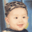 Pixelated close-up of a child's face with short brown hair, light skin, and a neutral expression against a blue background.