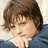 A person with brown hair in a blue shirt rests their chin on their hand, with red text 'i', 'love', and 'josh' appearing sequentially above their head.