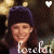 Two people in a pixelated image with text below them and a white heart symbol above, rendered in low-resolution style.