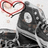 Pixelated image of a black and white sneaker with red heart outline above it, surrounded by text fragments on black background.