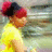 Pixelated image of a person with red hair wearing a yellow shirt, viewed from the side against a blurred background.