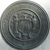 Circular grayscale icon with a textured, metallic appearance featuring a central emblem with curved lines and a small dot below it.