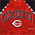 Static pixelated icon featuring a red baseball jersey with "CINCINNATI" text and a circular C logo, set against dark background.
