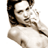 Static pixelated image of a person with long dark hair wearing a white top, cropped to show upper body and face against plain background.