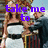 A woman in a white strapless dress with black accents stands beside a man in a dark suit, with text reading 'take me Sugarland Texas' in purple.
