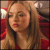 A static image of a woman with long light brown hair wearing red clothing, with text reading "KAREN SMITH" in white capital letters at the bottom right.