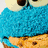 Pixelated image of a blue furry creature with large eyes holding a cookie, next to cyan text reading "Chloe F111 loves the cookie monster!".