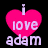 A pink heart-shaped icon with 'i love adam' text in white, displayed on a black background with slight pixelation.