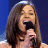 A 2x2 contact sheet of a four-frame animation featuring two people singing and speaking, with pixelated text below each frame on a blue background.