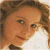 A pixelated image of a person with light brown hair and fair skin, wearing a white top against a dark green background with bright green text.