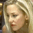 A 48x48 pixel buddy icon split into two frames showing a blonde woman on the left and green text on a dark background on the right, with visible pixelation and dithering effects.