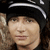 A person wearing a black beanie with white stripes appears in three showing subtle facial expression changes