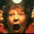 A pixelated contact sheet showing two frames of an animated icon featuring a character with dark hair and red clothing on the left, next to green text reading "Original Icons .com" on a solid green background.