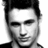 Black-and-white pixelated portrait of a person with short dark hair, neutral expression, and visible neck and shoulder area.
