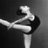 Black-and-white image of a dancer in mid-pose with pink text reading "it takes an athlete to dance but an artist to be a dancer" on black and gray backgrounds.