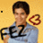 A person in a light blue shirt holds up 'FEZ' text with one hand, while the other hand forms a heart shape; background is yellow.