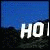 Pixelated blue sky and dark mountain landscape with partial white text reading 'HOLLYWI' and ')OD' across two sections.