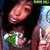 A pixelated image shows a person with dark hair holding a green and white object, partially visible against a blurred background.