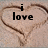 Two heart shapes drawn in sand with text reading "i love" and "YOU" above them, transitioning to a third heart shape with text below.
