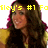 Pixelated image of a person with long dark hair wearing a black top and yellow sleeves, overlaid with yellow text reading "tley's #1 Fo".