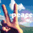 A hand forms a peace sign against a blue sky with white clouds, while the word 'peace' appears in light gray text over green terrain.