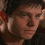 A pixelated image of a person with dark hair and light skin, showing three distinct facial expressions