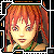 Pixelated portrait of a person with reddish-brown hair, light skin tone, and dark eyes, wearing green clothing against a black-and-white geometric border.
