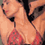 Pixelated static image of a person in a red bikini top with black straps, cropped to show upper torso and shoulders against a light background.