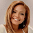 Pixelated close-up of a person with light brown hair, closed eyes, and a slight smile against a neutral background.