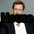 A man in a black suit jacket and white shirt appears in four with one showing the word 'House' over his face