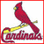 Red cardinal perched on yellow bat with 'Cardinals' text below, baseball stadium view in background, white and gray field sections visible.