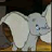 Static 48x48 pixel icon of a white cartoon elephant with large ears and trunk, standing on brown ground against dark background.