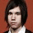 A person with shoulder-length dark hair appears in four distinct poses against orange and red backgrounds, wearing a white-collared shirt under a dark vest.