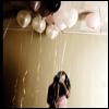 A static image shows a couple embracing under golden balloons against a light brown background.