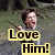 Pixelated image of a person holding a long object, with yellow text boxes reading "Love Him!" in bold black letters.