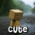Pixelated character with blocky brown body and light tan head stands against blurred green-gray background, white text 'CUTE' below.