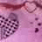 Pixelated image with pink and purple hues showing a partial circular shape on the right, scattered dark squares on the left, and a horizontal band across the top.